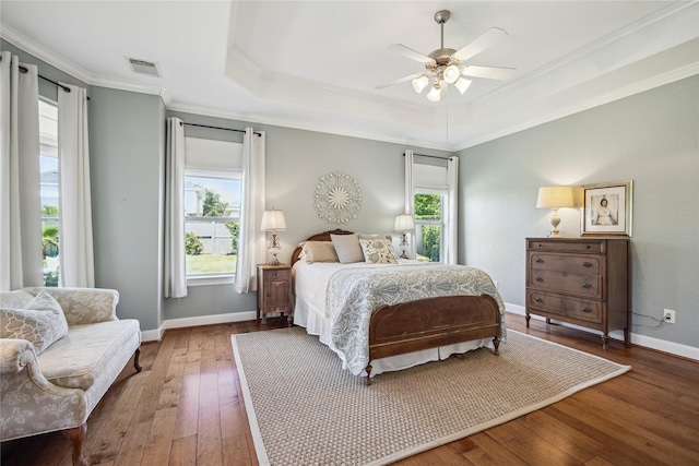 6338 Collina Springs Ct, Houston, TX 77041 - bedroom with multiple windows, crown molding, hardwood / wood-style floors, a tray ceiling, and baseboards