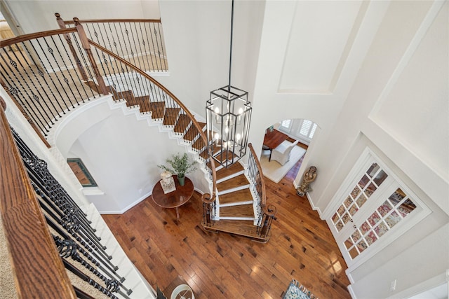 6338 Collina Springs Ct, Houston, TX 77041 - staircase with arched walkways, a high ceiling, hardwood / wood-style floors, and baseboards