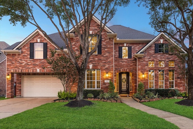 6338 Collina Springs Ct, Houston, TX 77041 - traditional home with concrete driveway, an attached garage, a front lawn, roof with shingles, and brick siding