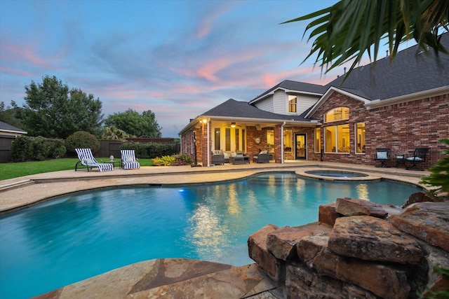 6338 Collina Springs Ct, Houston, TX 77041 - pool at dusk featuring a patio, an outdoor hangout area, and a pool with connected hot tub