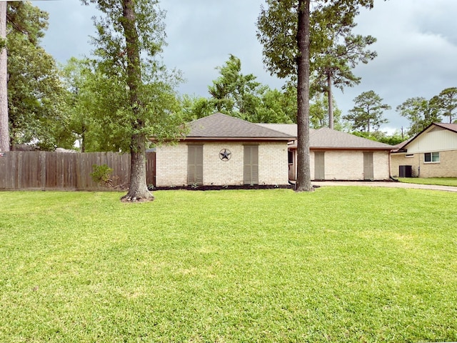 16007 Sailfin St, Crosby, TX 77532 - view of front of home featuring a shingled roof, brick siding, and central air condition unit