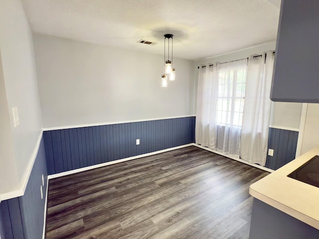 16007 Sailfin St, Crosby, TX 77532 - unfurnished dining area with a wainscoted wall and dark wood finished floors
