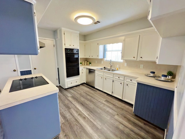 16007 Sailfin St, Crosby, TX 77532 - kitchen with black appliances, a sink, light wood-type flooring, white cabinetry, and light countertops