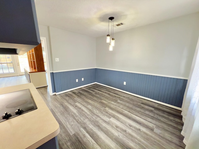 16007 Sailfin St, Crosby, TX 77532 - unfurnished dining area with wainscoting and wood finished floors