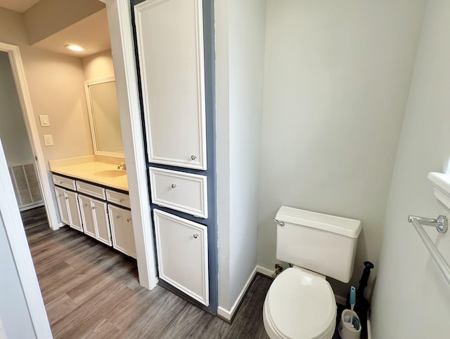 16007 Sailfin St, Crosby, TX 77532 - bathroom featuring wood finished floors, vanity, toilet, baseboards, and recessed lighting