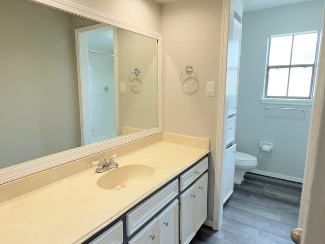 16007 Sailfin St, Crosby, TX 77532 - full bath with toilet, vanity, wood finished floors, and baseboards