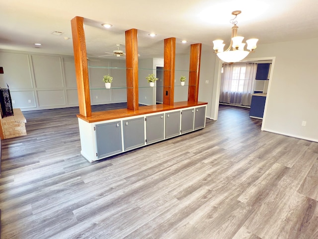 16007 Sailfin St, Crosby, TX 77532 - kitchen with light wood-style floors, a chandelier, open floor plan, and ceiling fan