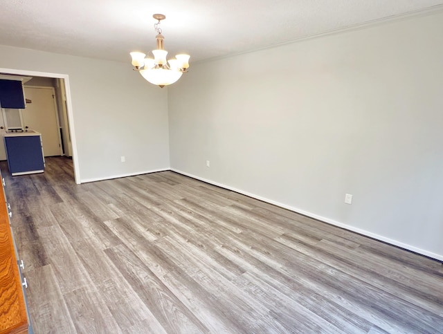 16007 Sailfin St, Crosby, TX 77532 - spare room featuring a chandelier, wood finished floors, and baseboards