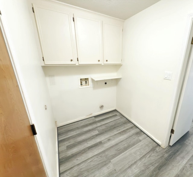 16007 Sailfin St, Crosby, TX 77532 - laundry room featuring hookup for an electric dryer, wood finished floors, cabinet space, and washer hookup