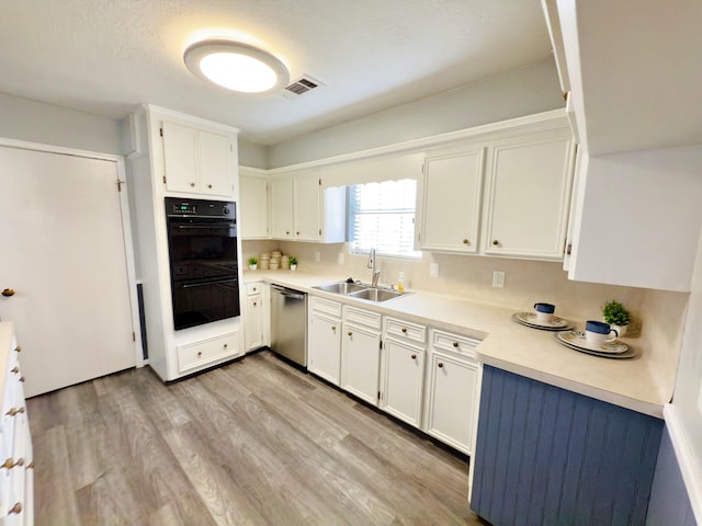 16007 Sailfin St, Crosby, TX 77532 - kitchen featuring dishwasher, a sink, light wood-style floors, light countertops, and white cabinets