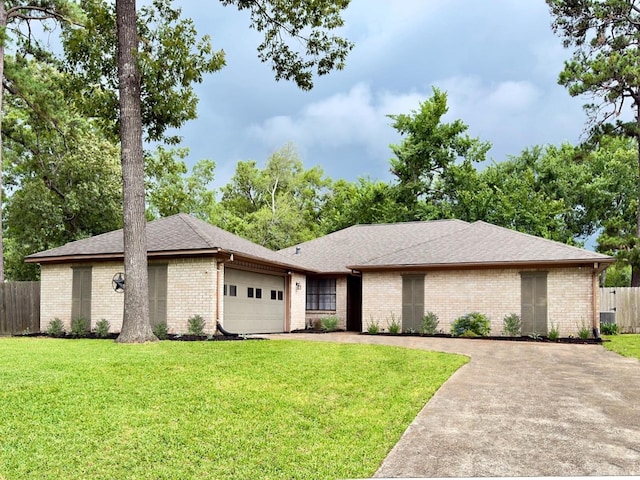 16007 Sailfin St, Crosby, TX 77532 - view of front of home featuring an attached garage, brick siding, driveway, and a shingled roof