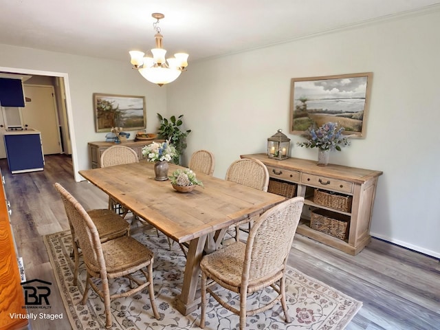 16007 Sailfin St, Crosby, TX 77532 - dining space with a chandelier, wood finished floors, and baseboards