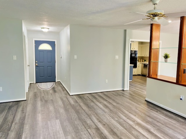 16007 Sailfin St, Crosby, TX 77532 - entryway featuring wood finished floors, ceiling fan, baseboards, and a textured ceiling