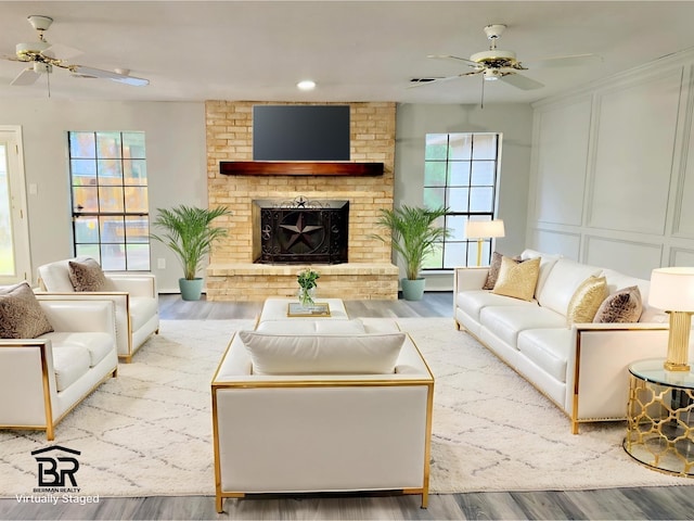 16007 Sailfin St, Crosby, TX 77532 - living area with a ceiling fan, wood finished floors, a decorative wall, a fireplace, and recessed lighting