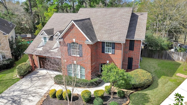 31 Brywood Pl, The Woodlands, TX 77382 - view of front facade with brick siding, a shingled roof, and driveway