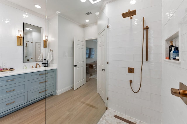 31 Brywood Pl, The Woodlands, TX 77382 - bathroom with ornamental molding, vanity, walk in shower, wood finished floors, and baseboards