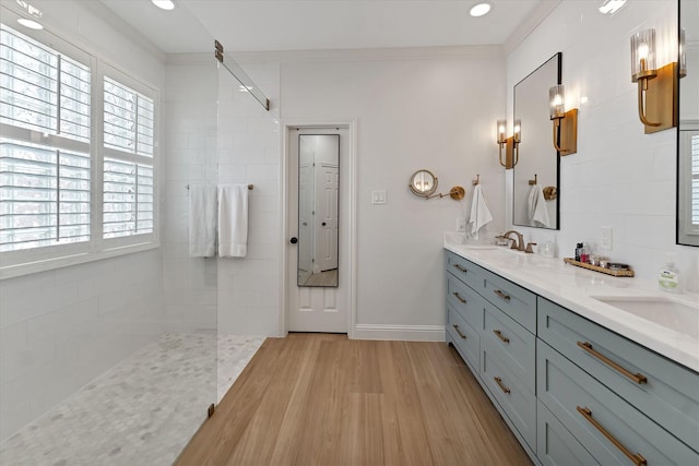 31 Brywood Pl, The Woodlands, TX 77382 - bathroom featuring double vanity, wood finished floors, walk in shower, crown molding, and baseboards