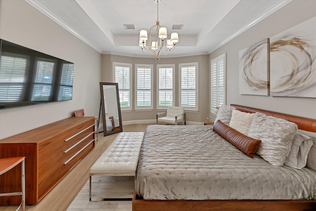 31 Brywood Pl, The Woodlands, TX 77382 - bedroom with a tray ceiling, a chandelier, light wood-style flooring, baseboards, and ornamental molding