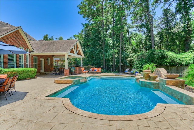 31 Brywood Pl, The Woodlands, TX 77382 - view of swimming pool with a patio area, a pool with connected hot tub, and an outdoor living space