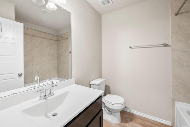 513 Bonnerville Ln, Magnolia, TX 77354 - bathroom with wood finished floors, toilet, vanity, and baseboards