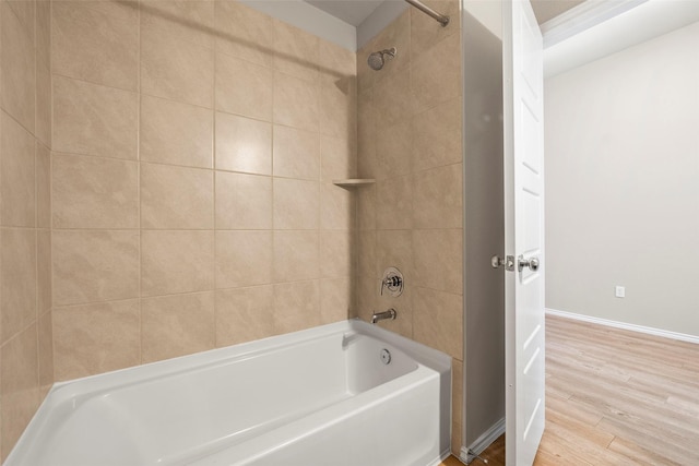 513 Bonnerville Ln, Magnolia, TX 77354 - full bathroom with wood finished floors, shower / bath combination, and baseboards