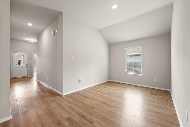 513 Bonnerville Ln, Magnolia, TX 77354 - spare room featuring plenty of natural light, light wood-style flooring, baseboards, recessed lighting, and lofted ceiling