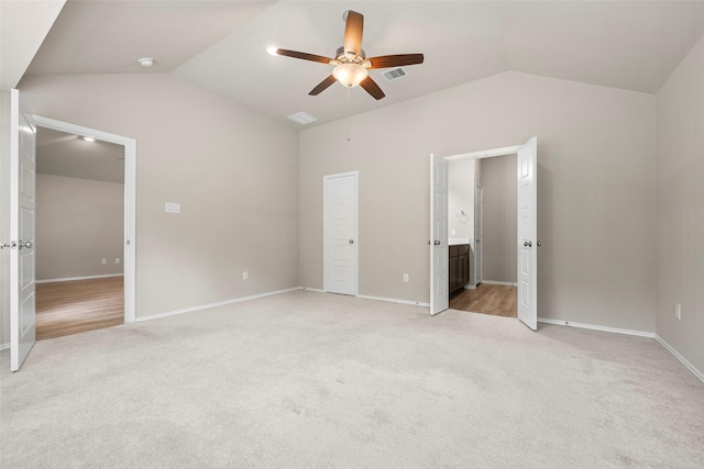 513 Bonnerville Ln, Magnolia, TX 77354 - unfurnished bedroom with lofted ceiling, light carpet, baseboards, a ceiling fan, and connected bathroom