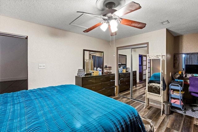 bedroom featuring wood finished floors, a textured ceiling, a closet, ceiling fan, and a textured wall
