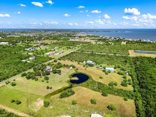 aerial view of property and surrounding area with a nearby body of water