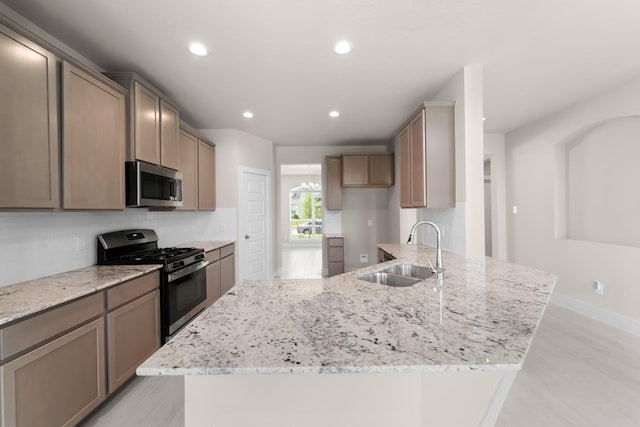 18423 Windy Knoll Way, Houston, TX 77084 - kitchen featuring appliances with stainless steel finishes, a sink, a peninsula, decorative backsplash, and recessed lighting