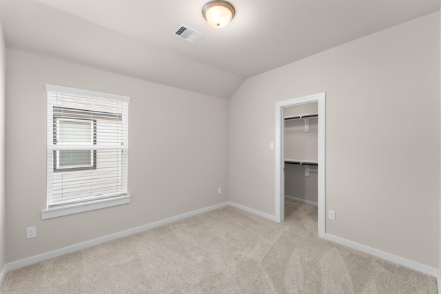 18423 Windy Knoll Way, Houston, TX 77084 - unfurnished bedroom with light carpet, baseboards, a walk in closet, vaulted ceiling, and a closet
