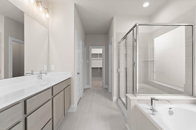 18423 Windy Knoll Way, Houston, TX 77084 - full bathroom featuring a stall shower, a spacious closet, a garden tub, baseboards, and vanity
