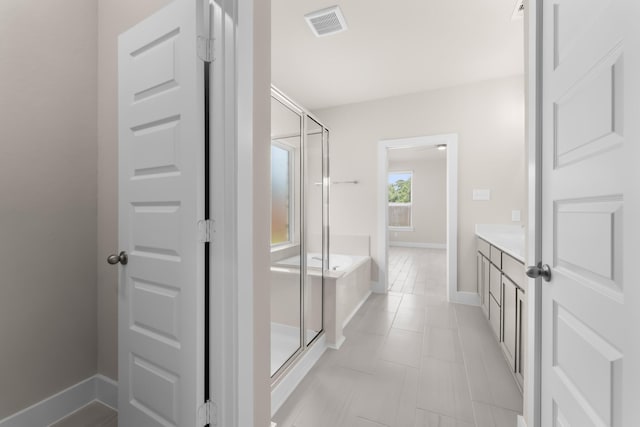 18423 Windy Knoll Way, Houston, TX 77084 - bathroom with a bath, a shower stall, vanity, and baseboards