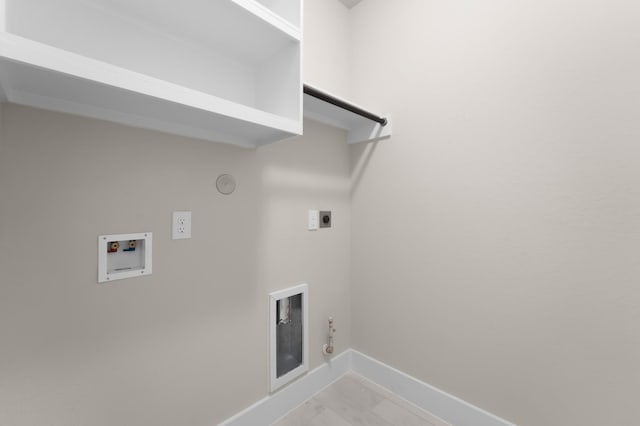 18423 Windy Knoll Way, Houston, TX 77084 - laundry area with gas dryer hookup, washer hookup, baseboards, hookup for an electric dryer, and light marble finish flooring