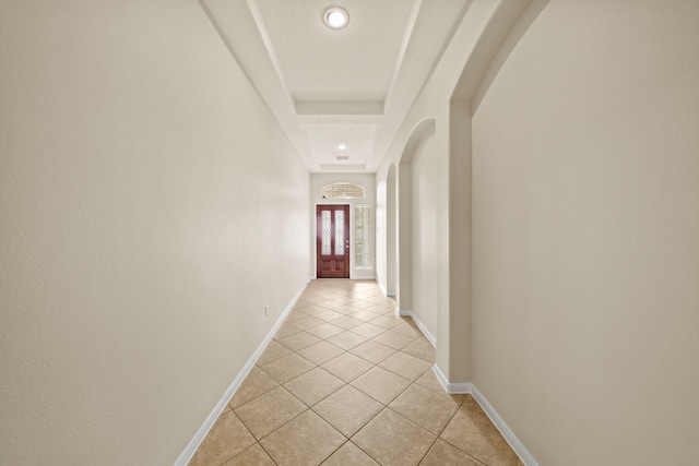 1910 Edenfield Ln, Sugar Land, TX 77479 - hallway with arched walkways, light tile patterned floors, baseboards, a tray ceiling, and recessed lighting