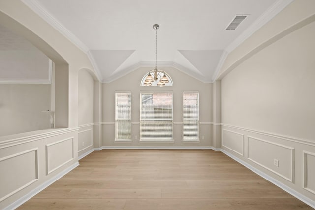 1910 Edenfield Ln, Sugar Land, TX 77479 - unfurnished dining area with a chandelier, a decorative wall, light wood-style floors, a wainscoted wall, and ornamental molding