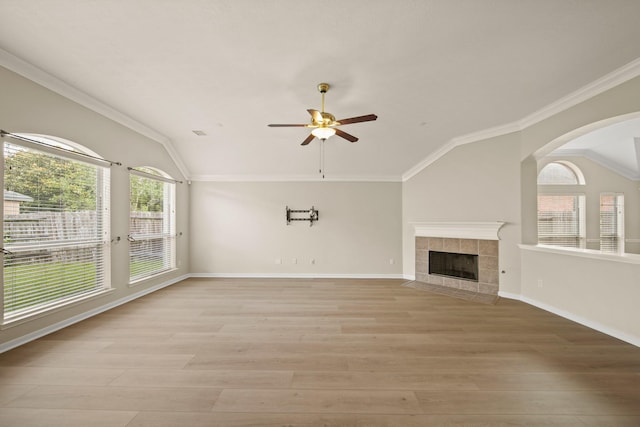 1910 Edenfield Ln, Sugar Land, TX 77479 - unfurnished living room featuring vaulted ceiling, a ceiling fan, light wood-type flooring, a fireplace, and baseboards