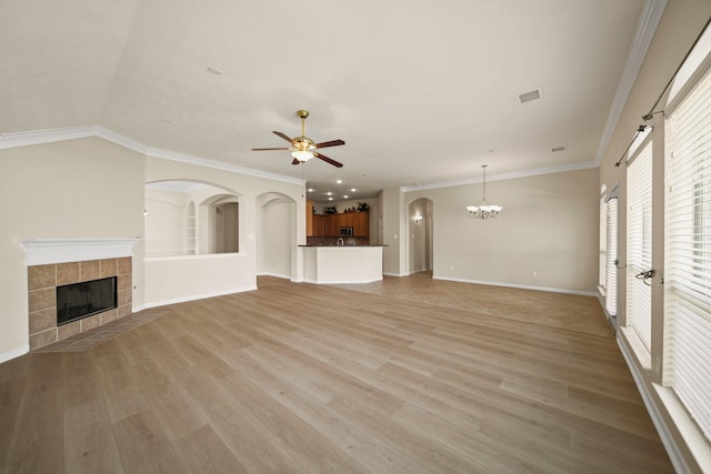 1910 Edenfield Ln, Sugar Land, TX 77479 - unfurnished living room with a fireplace, ceiling fan, light wood finished floors, a chandelier, and baseboards