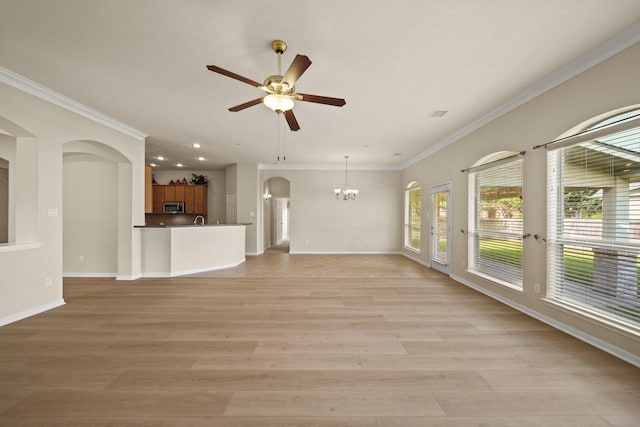 1910 Edenfield Ln, Sugar Land, TX 77479 - unfurnished living room with a ceiling fan, arched walkways, a chandelier, baseboards, and ornamental molding