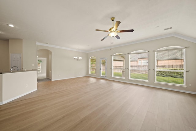 1910 Edenfield Ln, Sugar Land, TX 77479 - unfurnished living room featuring a chandelier, a ceiling fan, arched walkways, light wood-type flooring, and baseboards