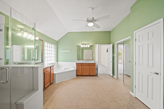 1910 Edenfield Ln, Sugar Land, TX 77479 - bathroom featuring ceiling fan, a bath, lofted ceiling, tile patterned flooring, and two vanities