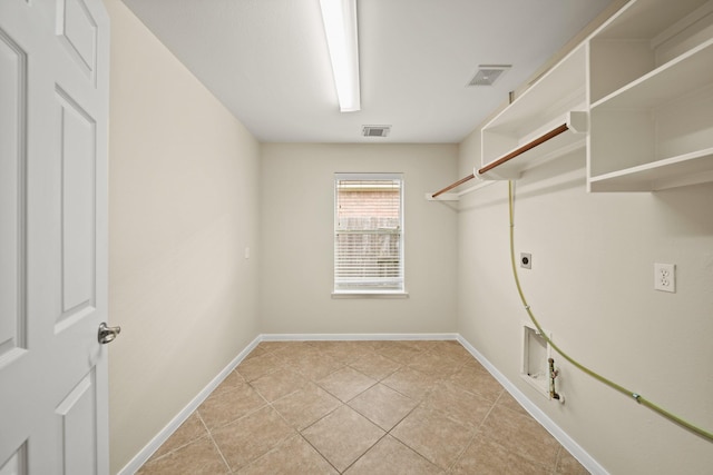 1910 Edenfield Ln, Sugar Land, TX 77479 - clothes washing area with gas dryer hookup, electric dryer hookup, light tile patterned floors, and baseboards