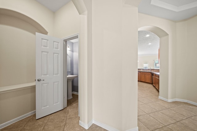 1910 Edenfield Ln, Sugar Land, TX 77479 - hall with light tile patterned floors, arched walkways, recessed lighting, and baseboards