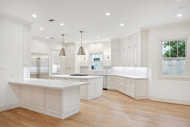 3707 Jardin St, Houston, TX 77005 - kitchen with appliances with stainless steel finishes, plenty of natural light, light countertops, light wood-style flooring, and recessed lighting