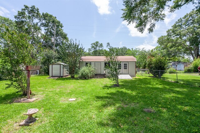 9385 Shepherd Dr, Beaumont, TX 77707 - view of yard featuring a storage unit and an outbuilding