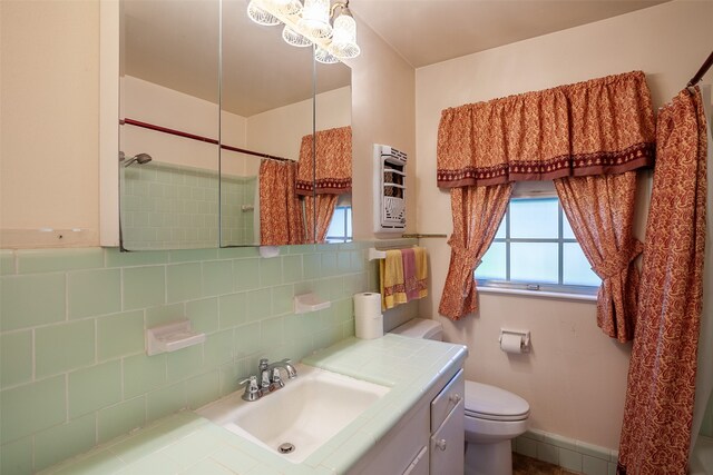 9385 Shepherd Dr, Beaumont, TX 77707 - full bath with decorative backsplash, toilet, vanity, baseboards, and curtained shower