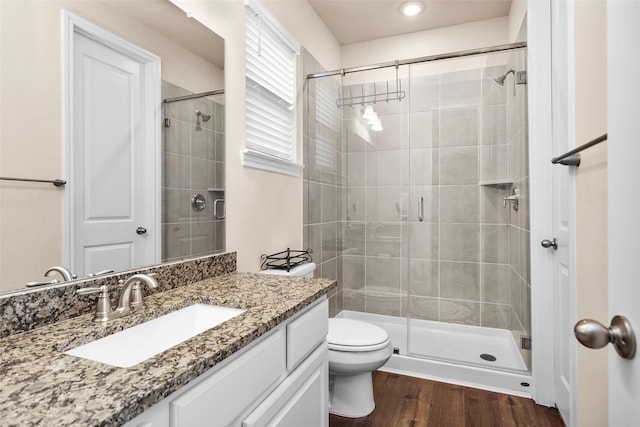 15527 Salmon Springs Dr, Conroe, TX 77302 - bathroom featuring a shower stall, vanity, toilet, and wood finished floors