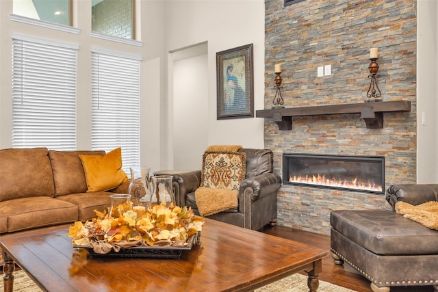 15527 Salmon Springs Dr, Conroe, TX 77302 - living area featuring wood finished floors, a stone fireplace, and a high ceiling