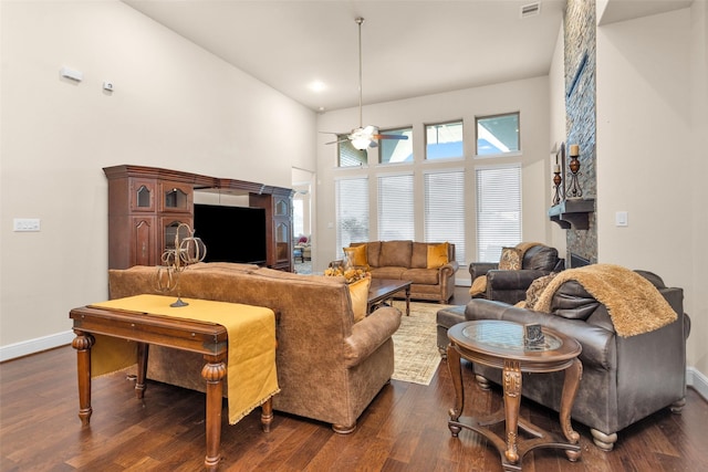 15527 Salmon Springs Dr, Conroe, TX 77302 - living area featuring a ceiling fan, a fireplace, dark wood-style flooring, baseboards, and a towering ceiling