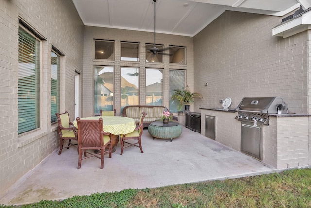 15527 Salmon Springs Dr, Conroe, TX 77302 - view of patio / terrace with exterior kitchen, outdoor dining space, and grilling area